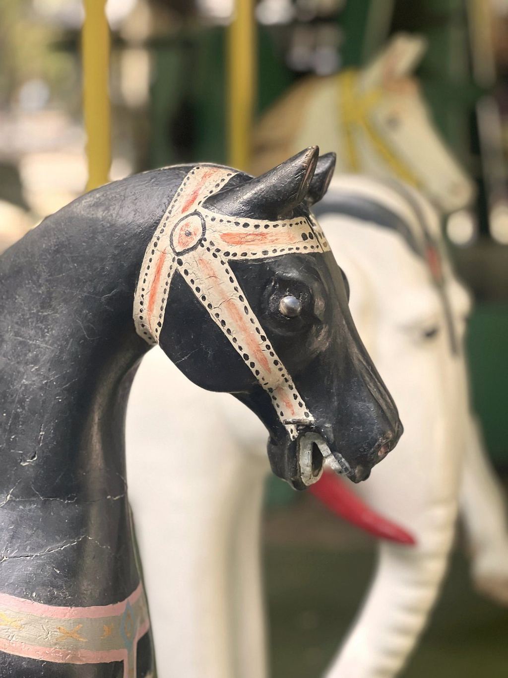 An ornate hand-painted carousel horse at a Paris garden carousel
