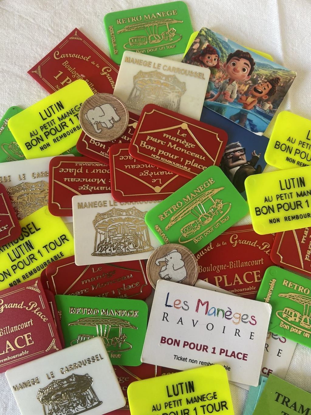 A collection of paper and plastic carousel tickets gathered over years from carousels across Paris