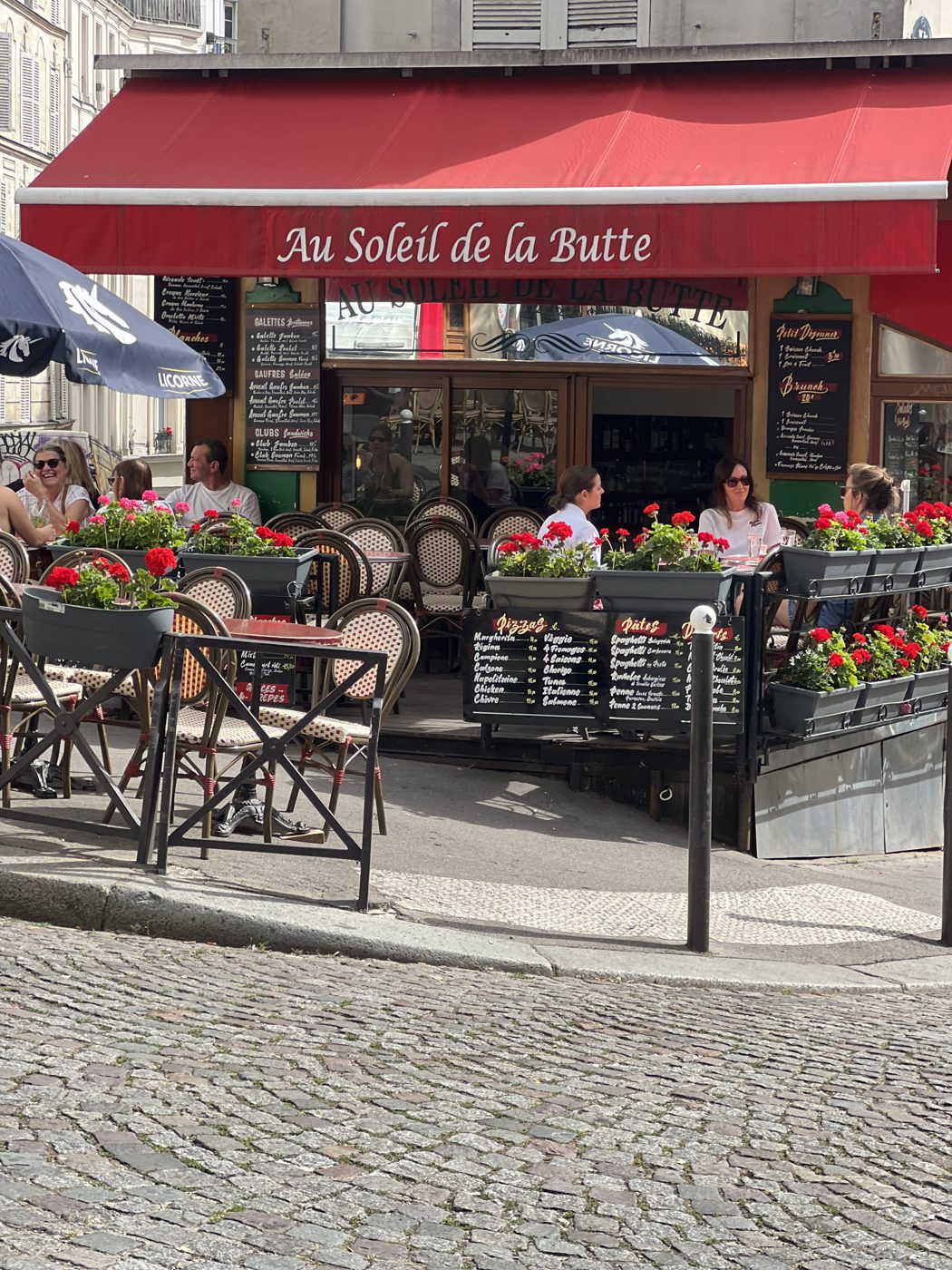 A flower-framed café terrace at the foot of Montmartre, Paris