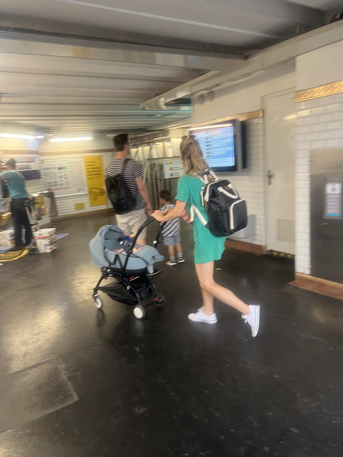 A parent with a stroller on a Paris métro platform