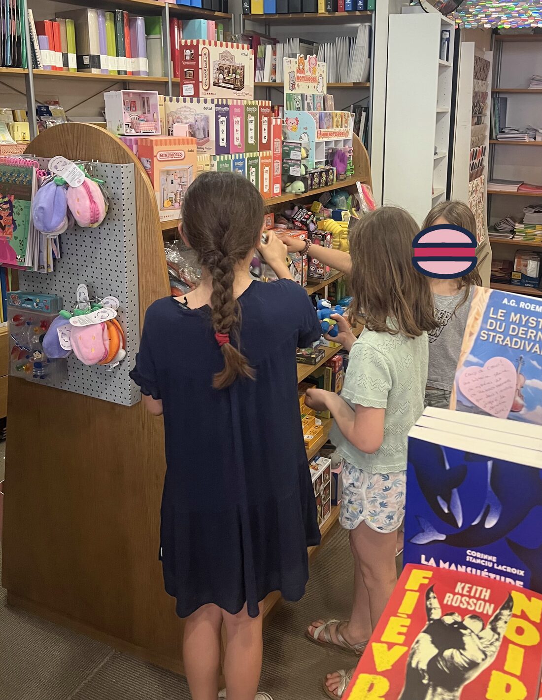 Children browsing toys and stationery inside a Paris librairie-papeterie