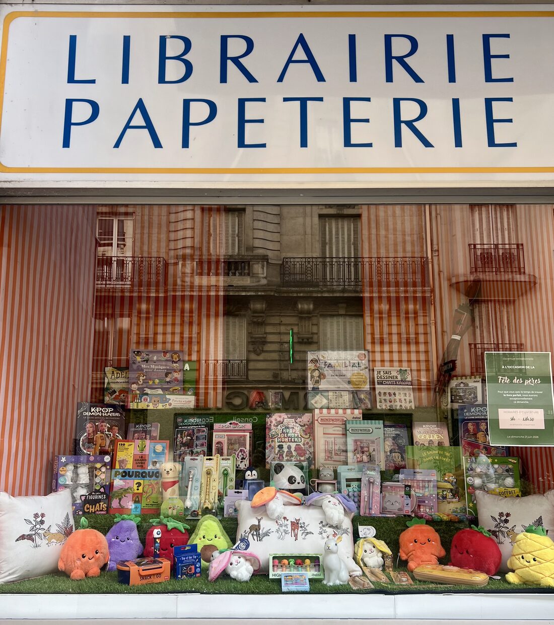 A Paris « Librairie Papeterie » shop window full of books, plush toys and stationery